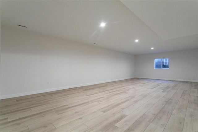 spare room with light wood-style floors, recessed lighting, visible vents, and baseboards