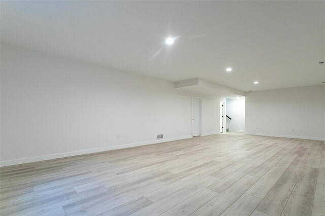 spare room featuring light wood-style flooring, visible vents, baseboards, and recessed lighting