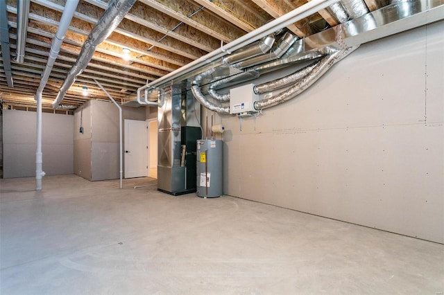 unfinished below grade area featuring electric water heater and heating unit