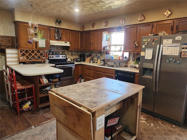 kitchen with a sink, stainless steel appliances, light countertops, under cabinet range hood, and backsplash