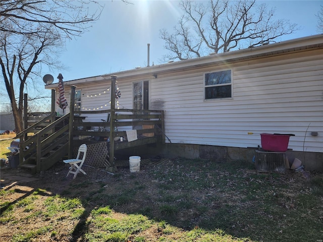 back of property with stairs and a deck