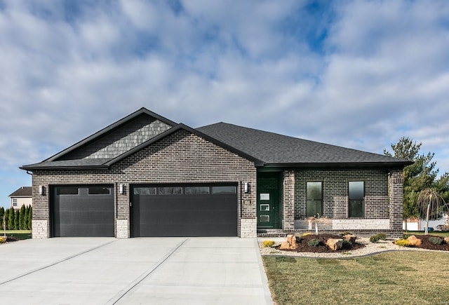 view of front of property featuring driveway, brick siding, a front lawn, and an attached garage