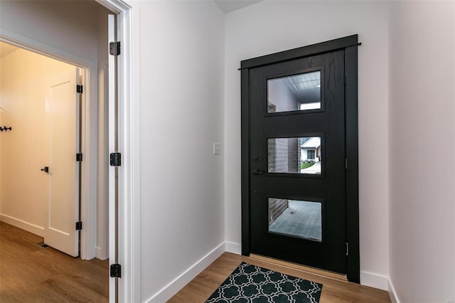 foyer with baseboards and light wood finished floors