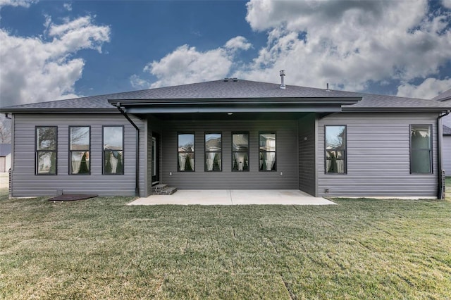 rear view of property with roof with shingles, a patio, and a yard