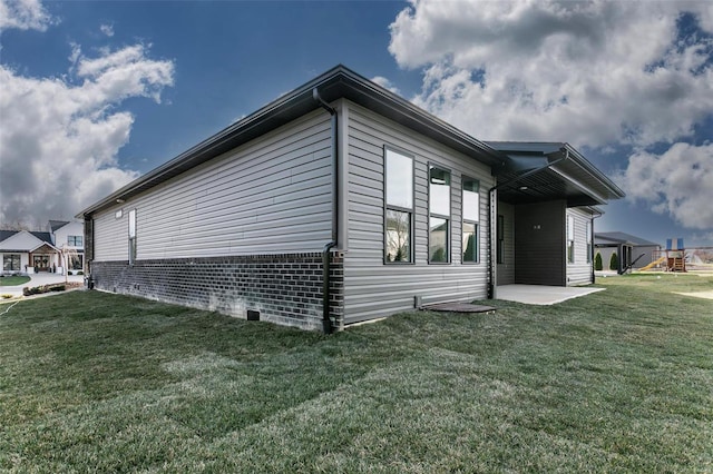 view of home's exterior featuring a patio area and a lawn