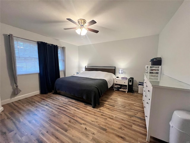 bedroom featuring ceiling fan, light wood finished floors, and baseboards