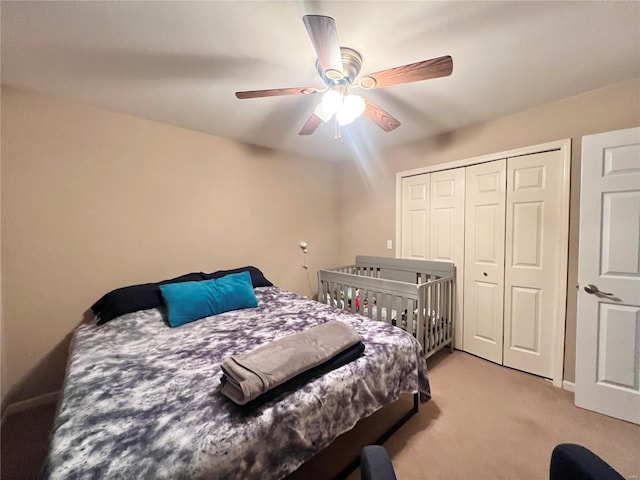 bedroom featuring a closet, light carpet, and ceiling fan