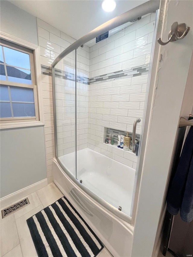 full bath with visible vents, shower / bath combination with glass door, and baseboards