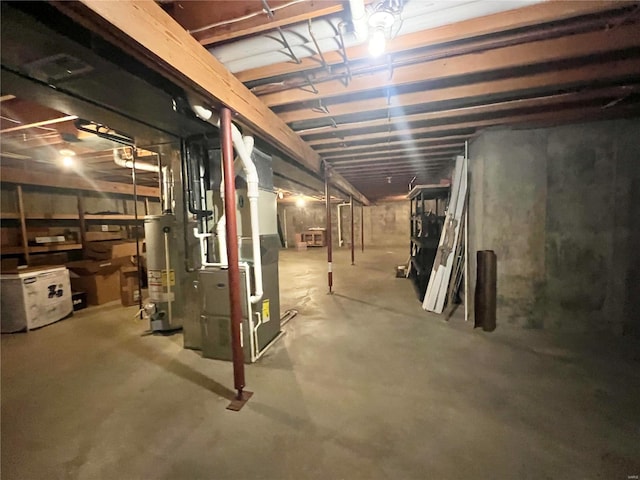 unfinished below grade area featuring water heater and heating unit