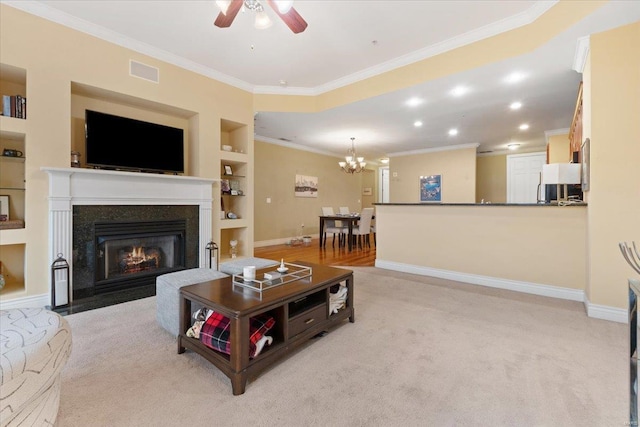 living area featuring built in features, crown molding, visible vents, a fireplace with flush hearth, and baseboards