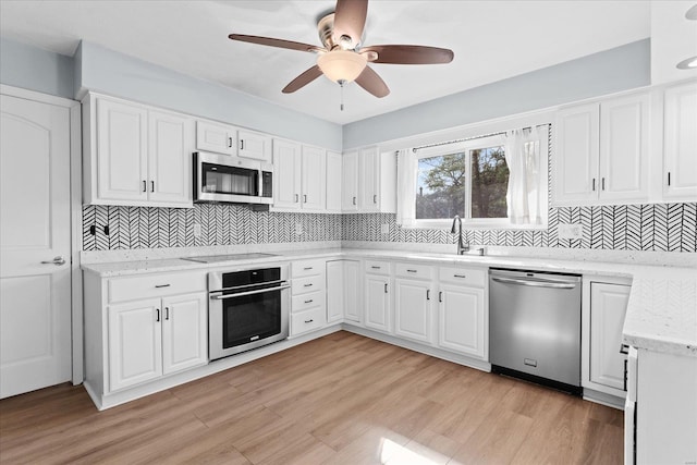 kitchen featuring white cabinetry, stainless steel appliances, and a sink