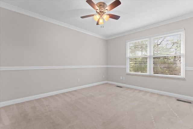 unfurnished room with visible vents, baseboards, and ornamental molding