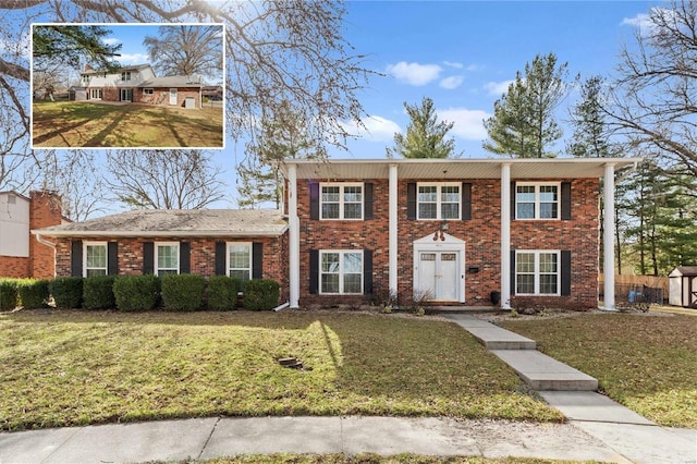 view of front of property featuring brick siding and a front lawn