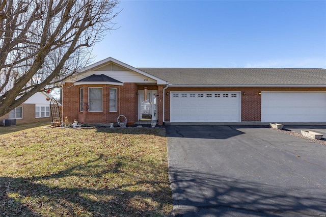 view of front of home with aphalt driveway, brick siding, central air condition unit, an attached garage, and a front yard