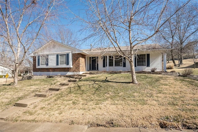 ranch-style house featuring a front yard and brick siding