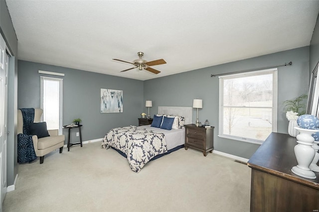 bedroom with ceiling fan, a textured ceiling, carpet, and baseboards