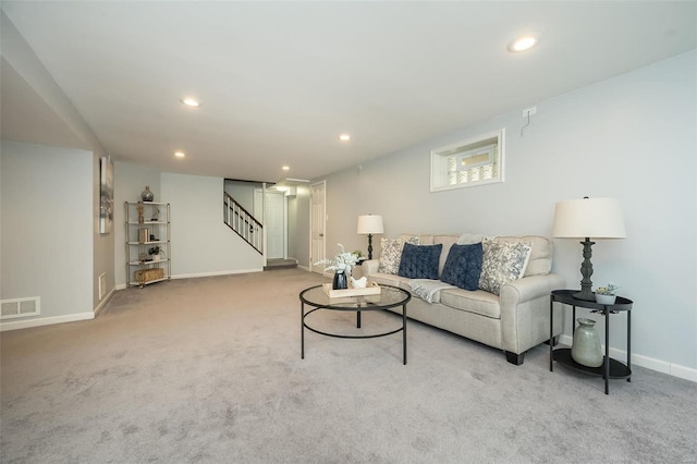 carpeted living area with stairway, recessed lighting, visible vents, and baseboards