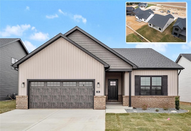 view of front of property featuring brick siding, board and batten siding, a shingled roof, concrete driveway, and an attached garage