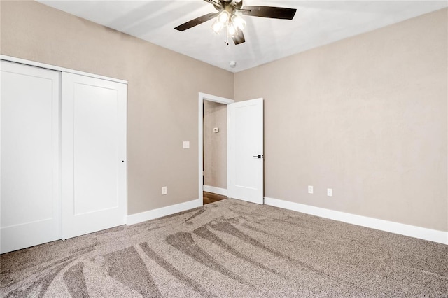 unfurnished bedroom with a closet, carpet flooring, ceiling fan, and baseboards