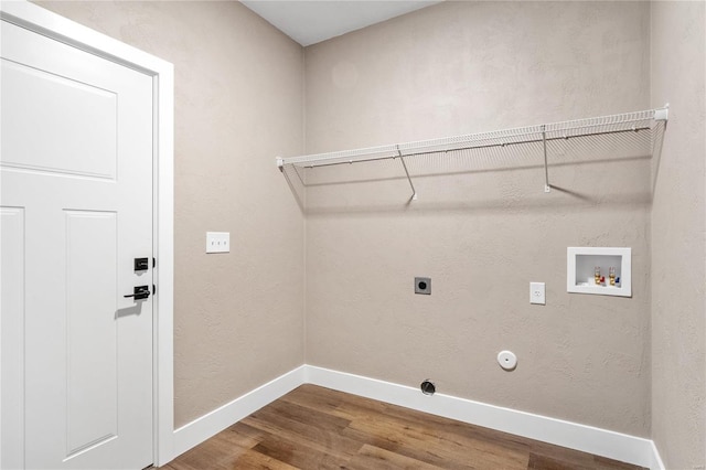 laundry area with baseboards, laundry area, hookup for a washing machine, wood finished floors, and electric dryer hookup