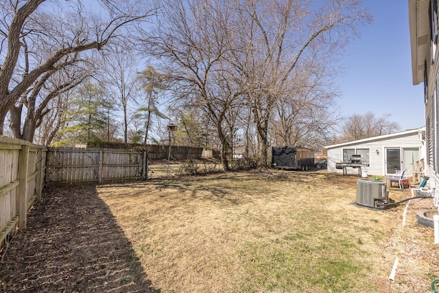 view of yard featuring central AC unit and a fenced backyard