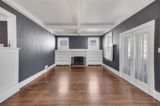 unfurnished living room featuring a fireplace with flush hearth, beamed ceiling, baseboards, and wood finished floors