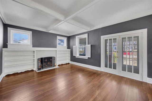 unfurnished living room with a fireplace with flush hearth, beam ceiling, baseboards, and hardwood / wood-style flooring