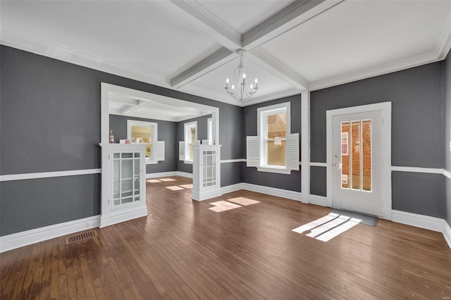 empty room featuring coffered ceiling, wood finished floors, beam ceiling, and baseboards