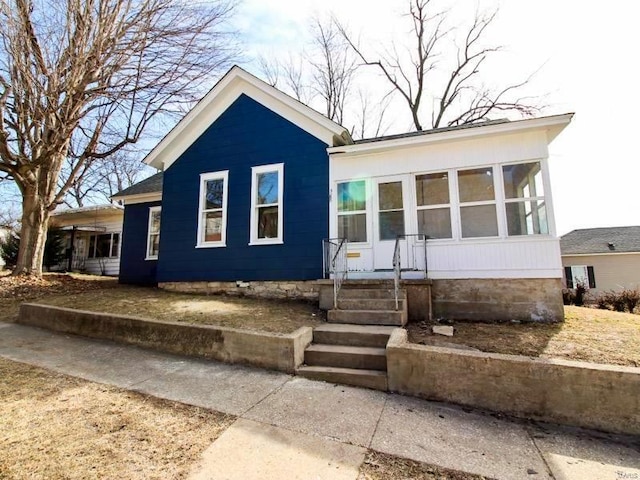 view of front of property with a sunroom