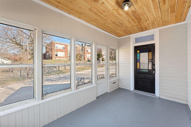 unfurnished sunroom with a wealth of natural light and wooden ceiling