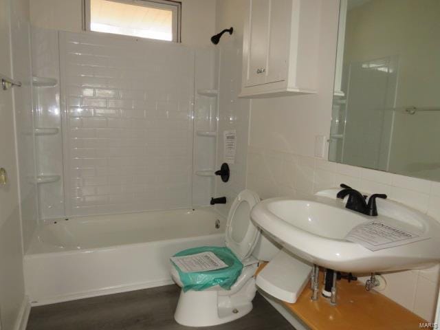 bathroom featuring  shower combination and decorative backsplash