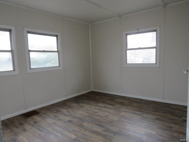 empty room with visible vents and wood finished floors