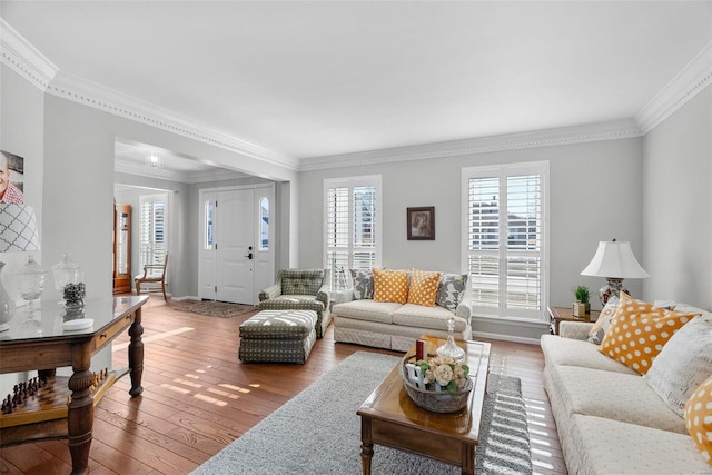 living room with wood-type flooring and crown molding