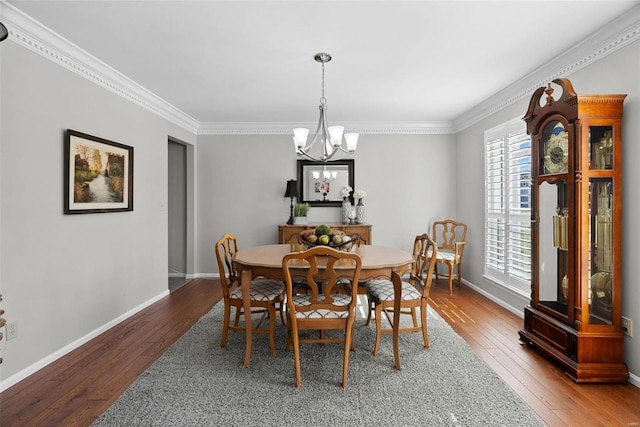 dining area featuring a notable chandelier, ornamental molding, baseboards, and wood-type flooring