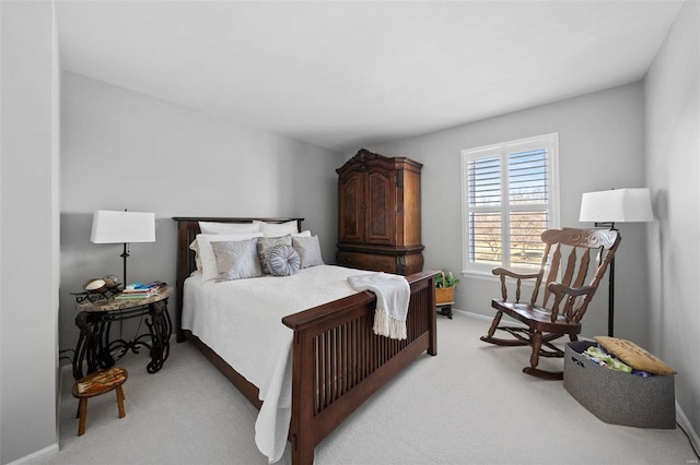 bedroom featuring baseboards and light carpet