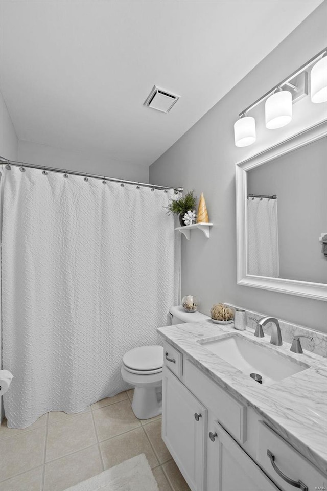 full bath with visible vents, toilet, vanity, and tile patterned flooring