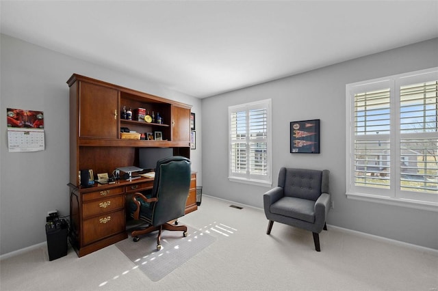 office space featuring light carpet, visible vents, and baseboards