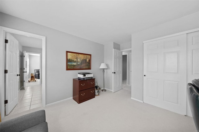 interior space with baseboards and light colored carpet