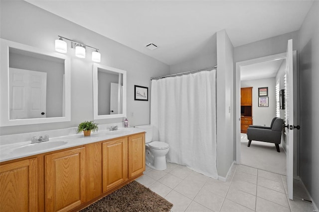 full bathroom with tile patterned flooring, double vanity, visible vents, and a sink