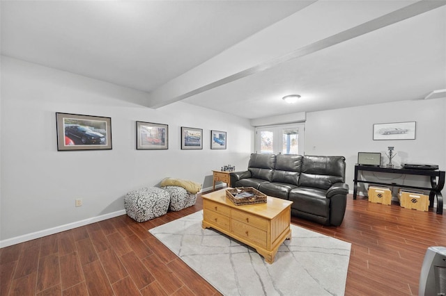 living area with beamed ceiling, wood finished floors, and baseboards