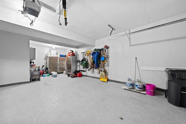 garage with a garage door opener and baseboards