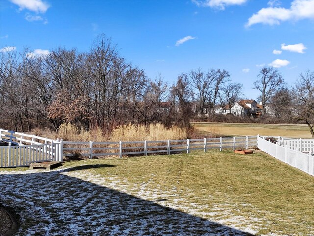 view of yard with a rural view and fence