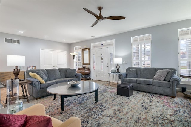 living area featuring visible vents, a ceiling fan, and recessed lighting