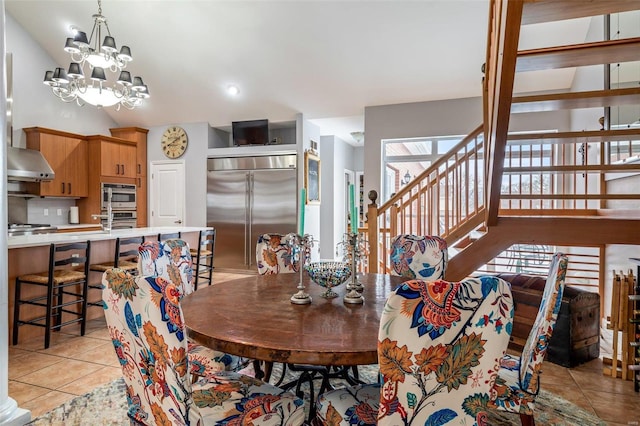 dining area featuring light tile patterned floors and an inviting chandelier