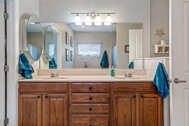 bathroom with double vanity, a shower, and a sink