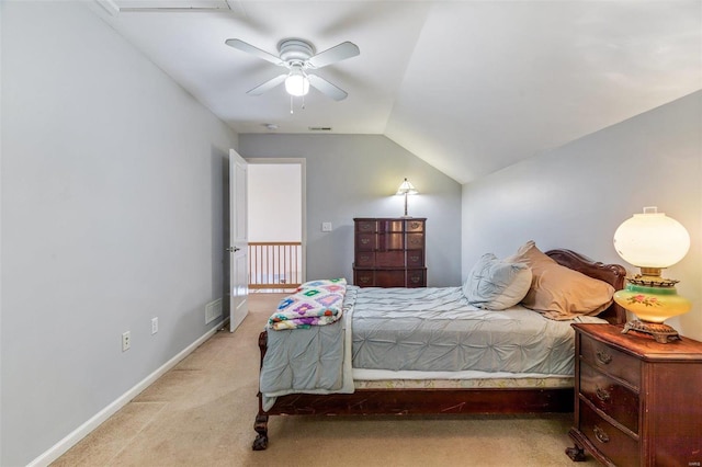 bedroom with light colored carpet, visible vents, vaulted ceiling, ceiling fan, and baseboards