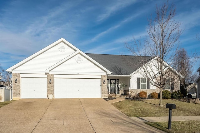 single story home with a garage, driveway, and brick siding