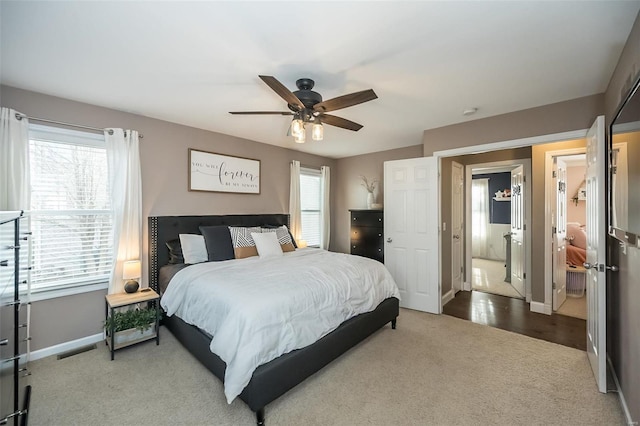 carpeted bedroom featuring visible vents, ceiling fan, and baseboards