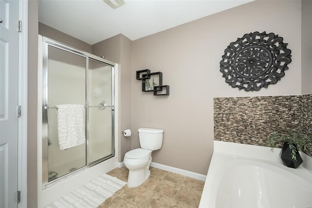 bathroom with toilet, a stall shower, a bath, and baseboards