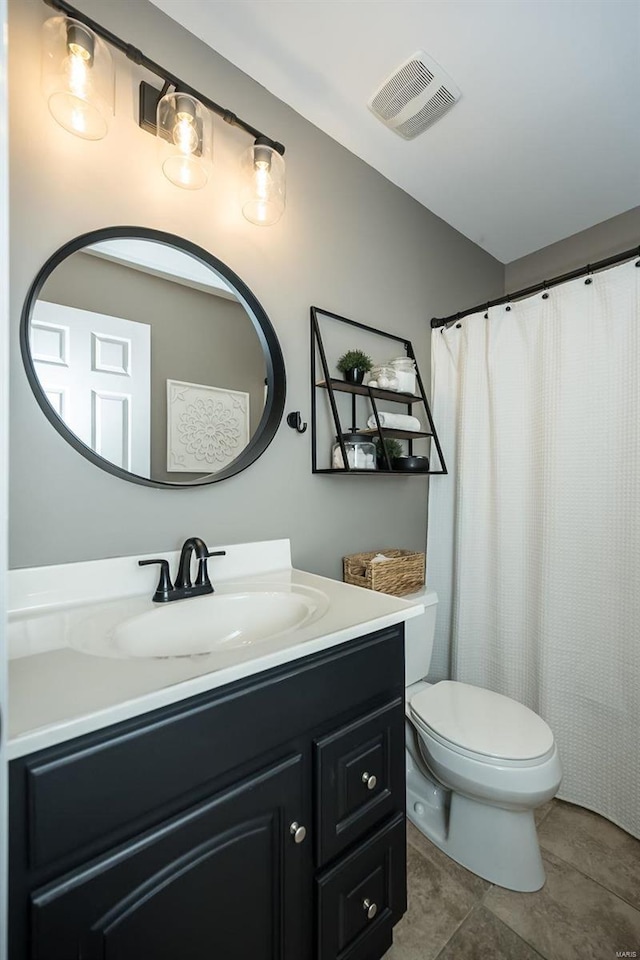 bathroom featuring tile patterned flooring, toilet, a shower with shower curtain, vanity, and visible vents